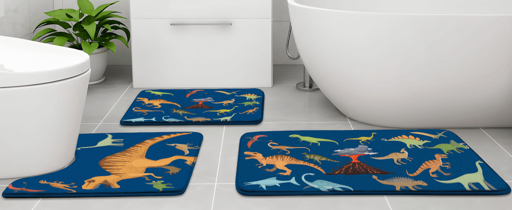 Khelo Dinosaur-Themed Kids Bath Mat Set in a stylish bathroom setting, featuring a fun prehistoric design with vibrant dinosaurs and volcano graphics. This 3-piece anti-slip bath rug set includes a large bath mat, a contour toilet mat, and a small rug, offering ultra-soft comfort and superior water absorption. Designed to keep floors dry and safe, these memory foam mats provide a cozy and playful touch to any child’s bathroom. Ideal for dinosaur-loving kids, this set combines safety, and durability