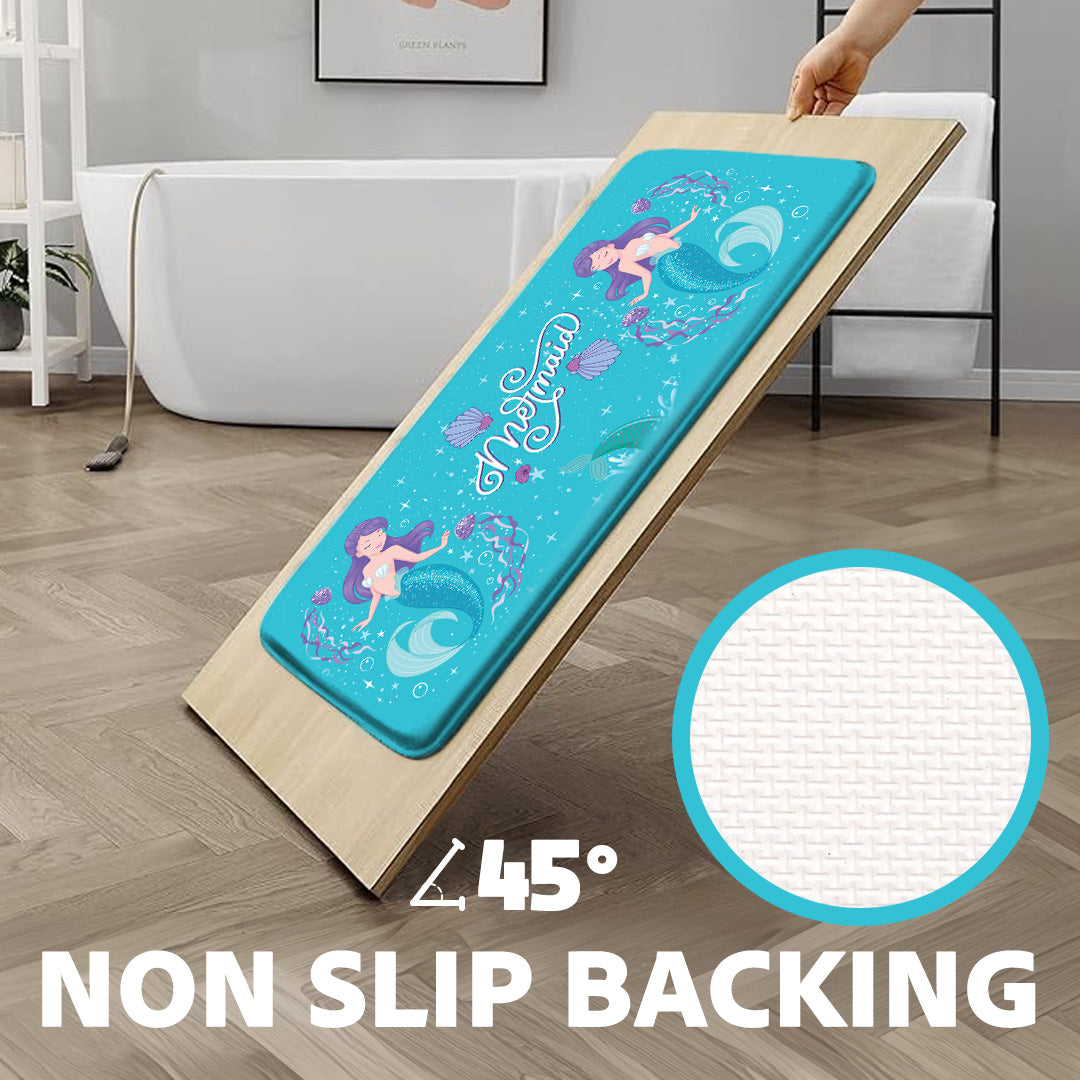 Khelo Mermaid-Themed Kids Bath Mat with Anti-Slip Backing, designed for maximum safety and comfort. This waterproof bath rug features a whimsical mermaid design with seashell accents, making it a fun and stylish addition to any child's bathroom. Shown on a 45-degree incline, the strong non-slip grip prevents movement, ensuring stability and safety. Crafted from ultra-soft, cushioned material, this bath mat provides a plush feel while being durable and easy to clean. Perfect for ocean-themed or mermaid-lovin