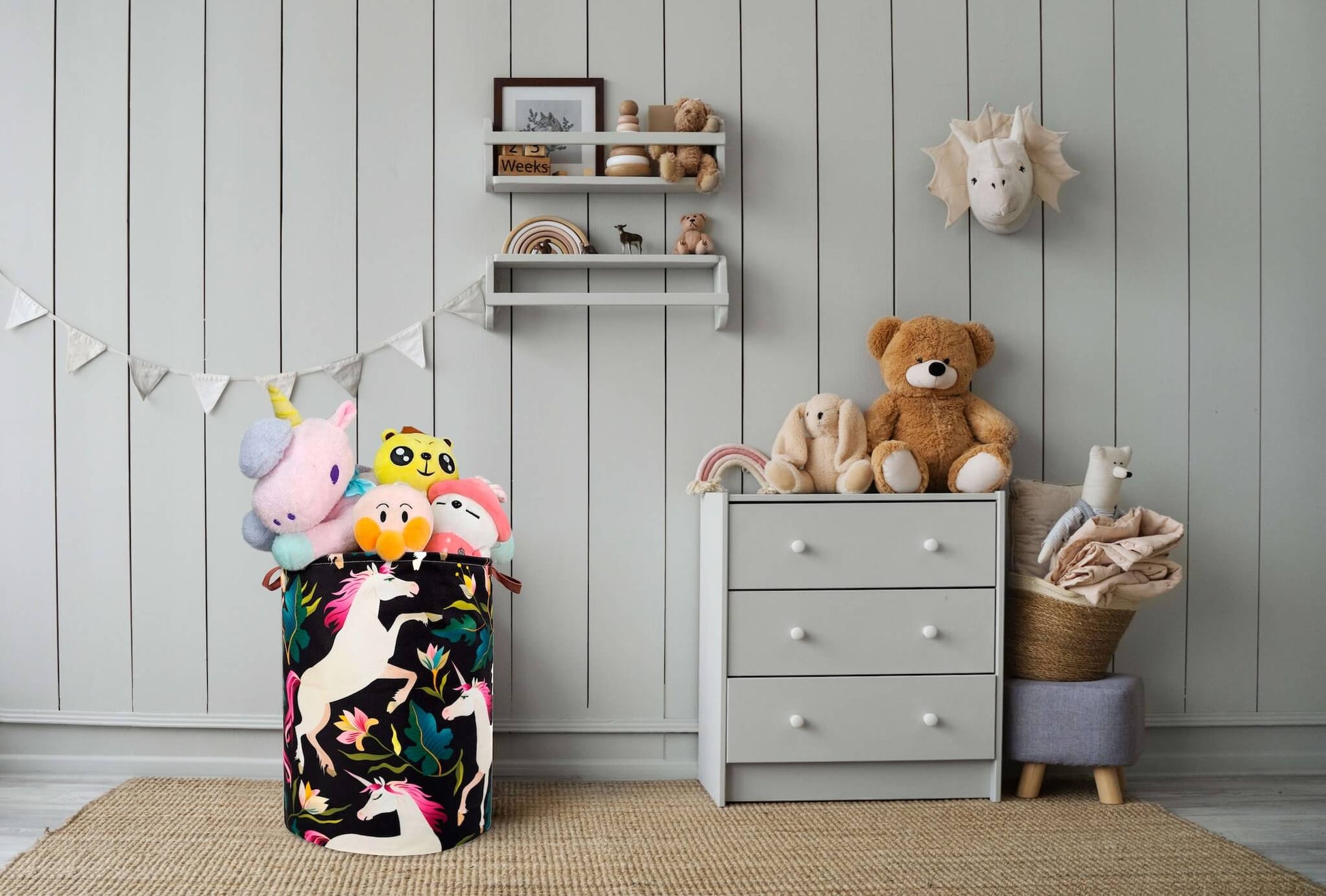 Khelo premium collapsible kids laundry hamper with a vibrant floral unicorn design, displayed in a stylish and organized nursery filled with plush toys and modern decor.